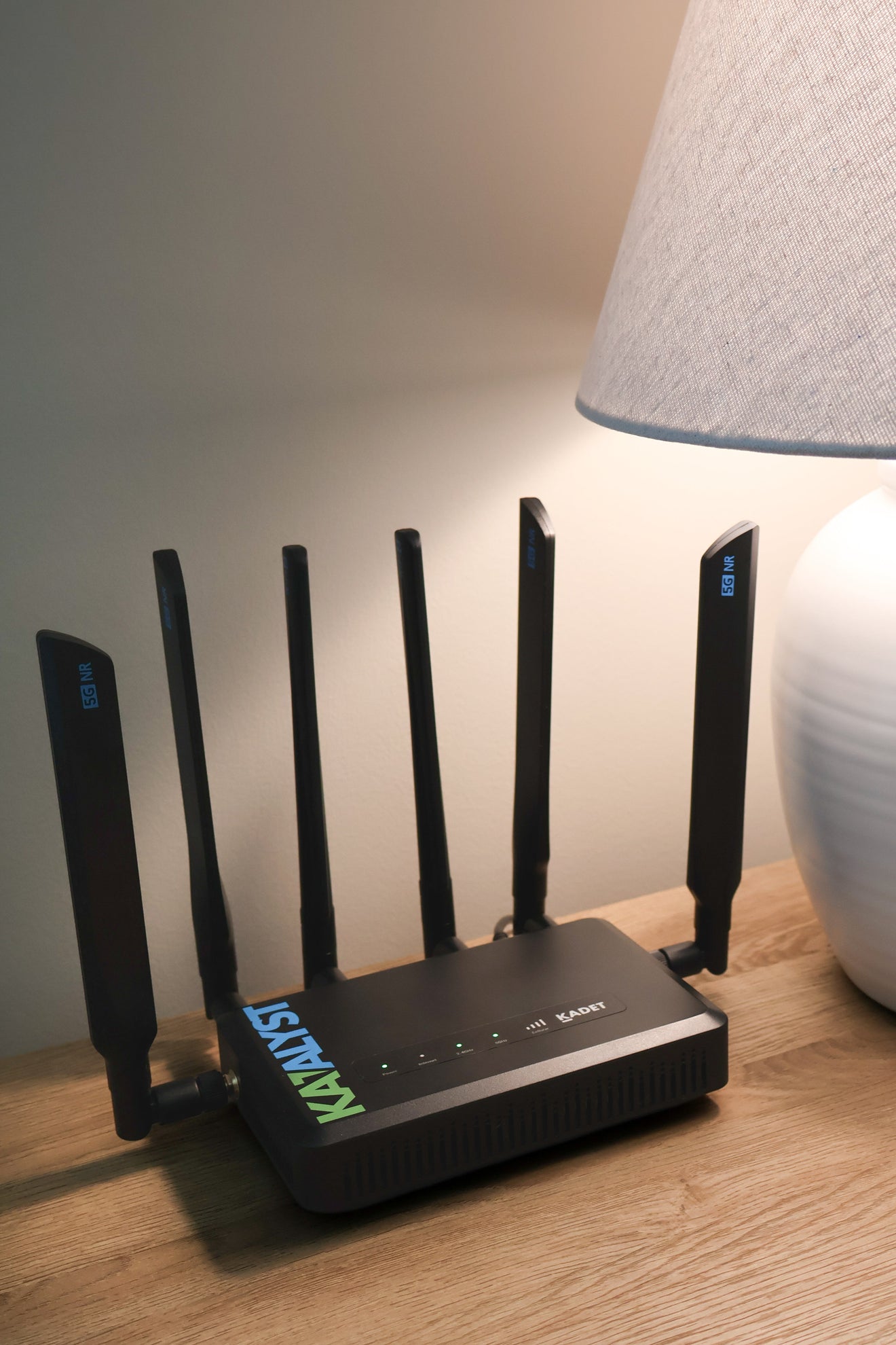 Katalyst Kadet K300NB 5G business router on a side table in an indoor business setting.