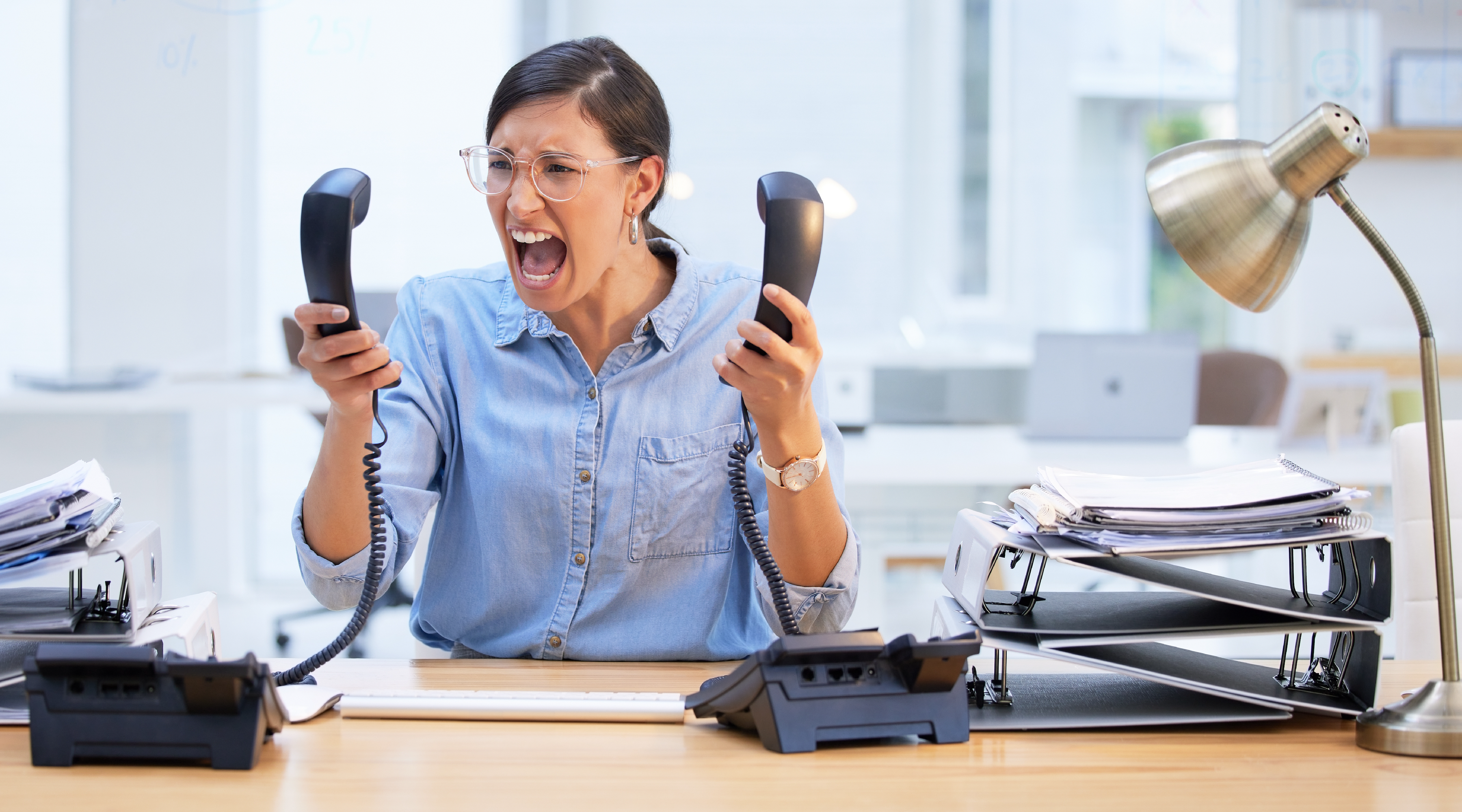 Business professional frustrated by unreliable office phone and network connectivity.