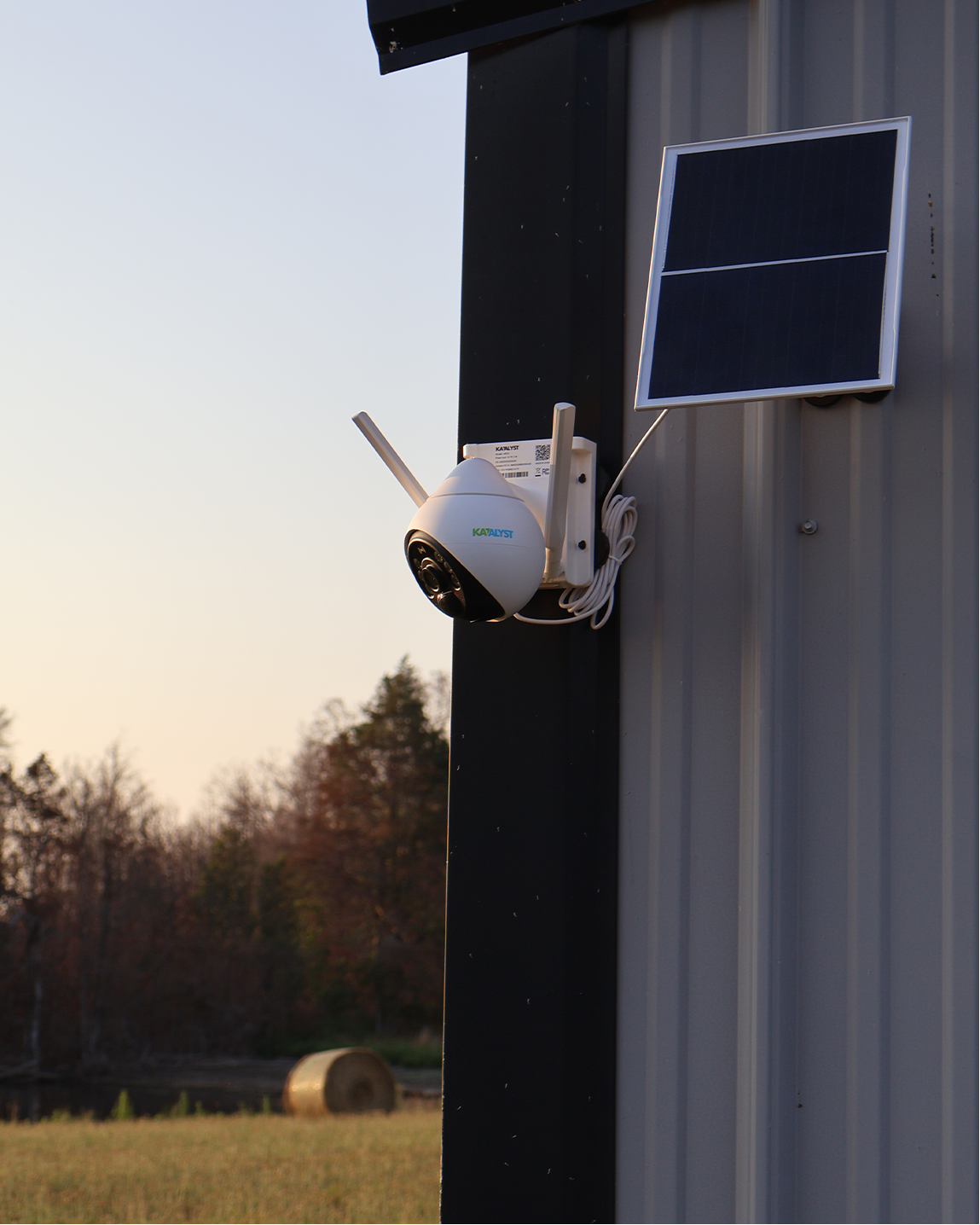 Hawk solar-powered security camera mounted on a rural building for remote property monitoring.