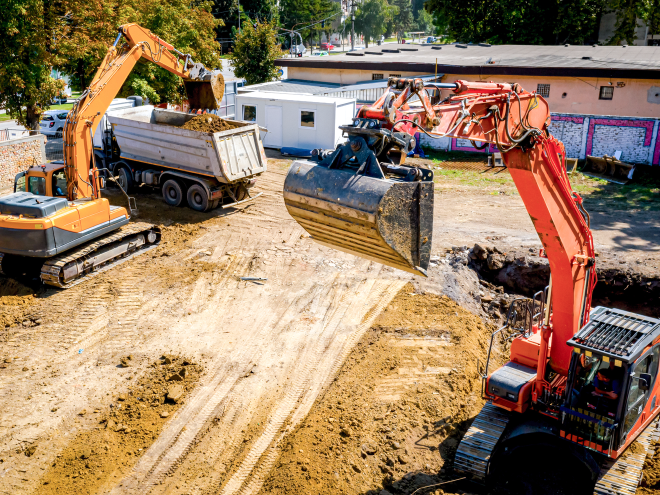 Excavator moving earth at a construction site.