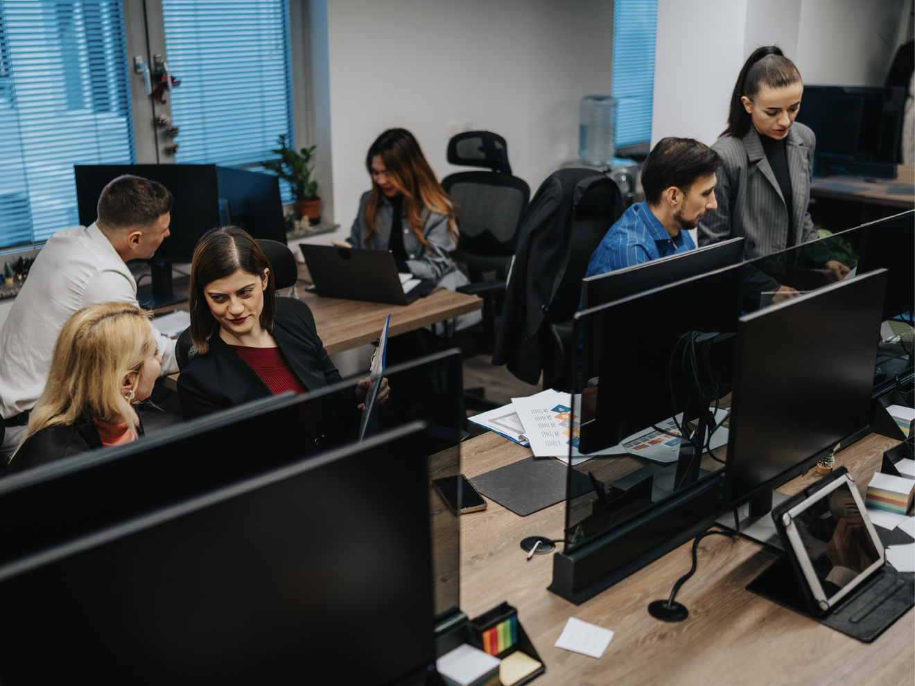 Office team working on multiple computers connected to a high-capacity business Wi-Fi network.