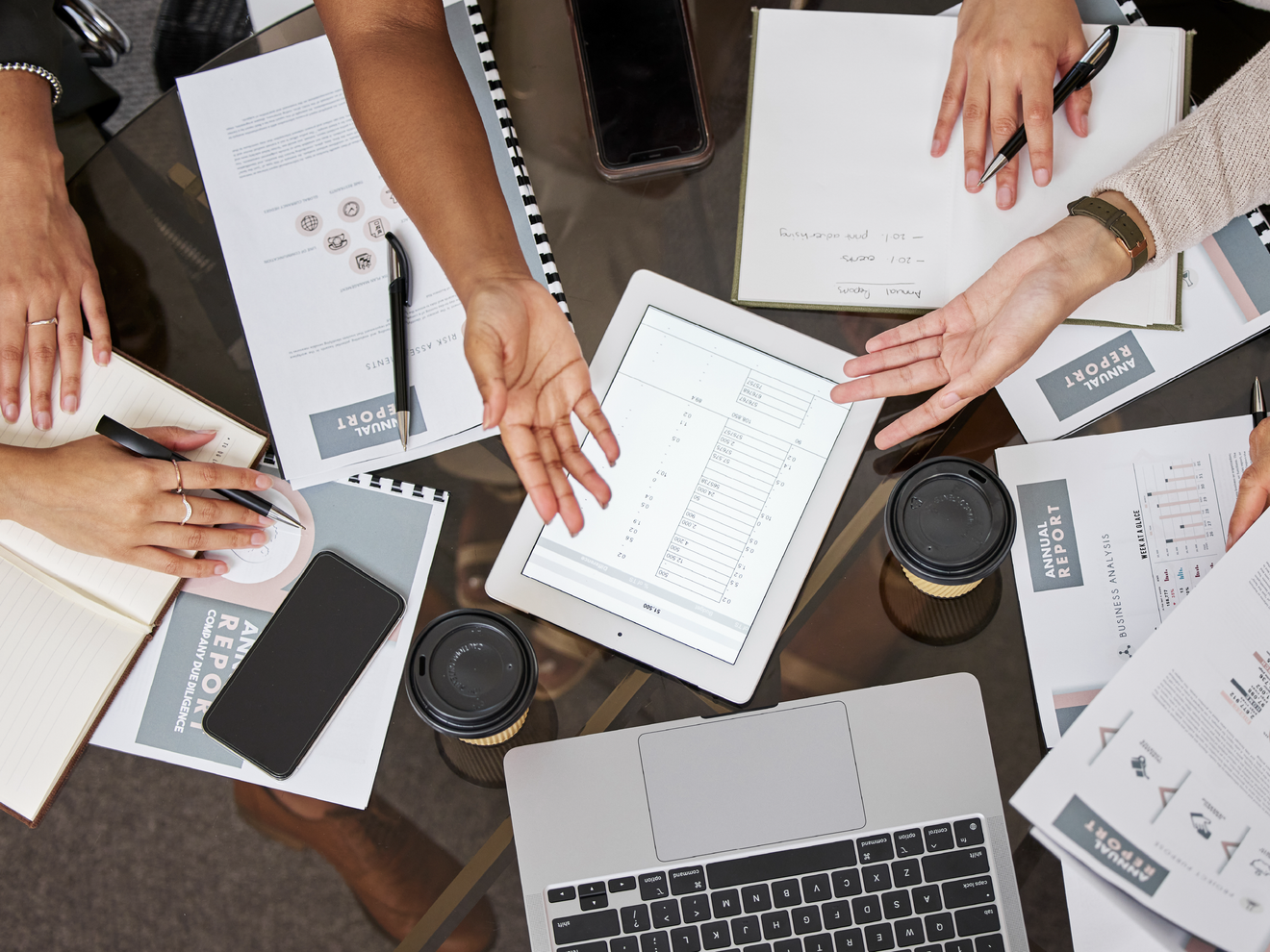 Team collaborating with laptops, tablets, and mobile devices connected to a high-capacity business network.