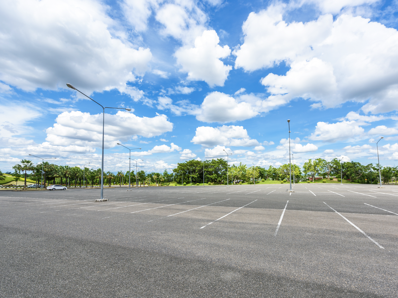 Wide outdoor parking area monitored by a Hawk security camera with wide-angle coverage.